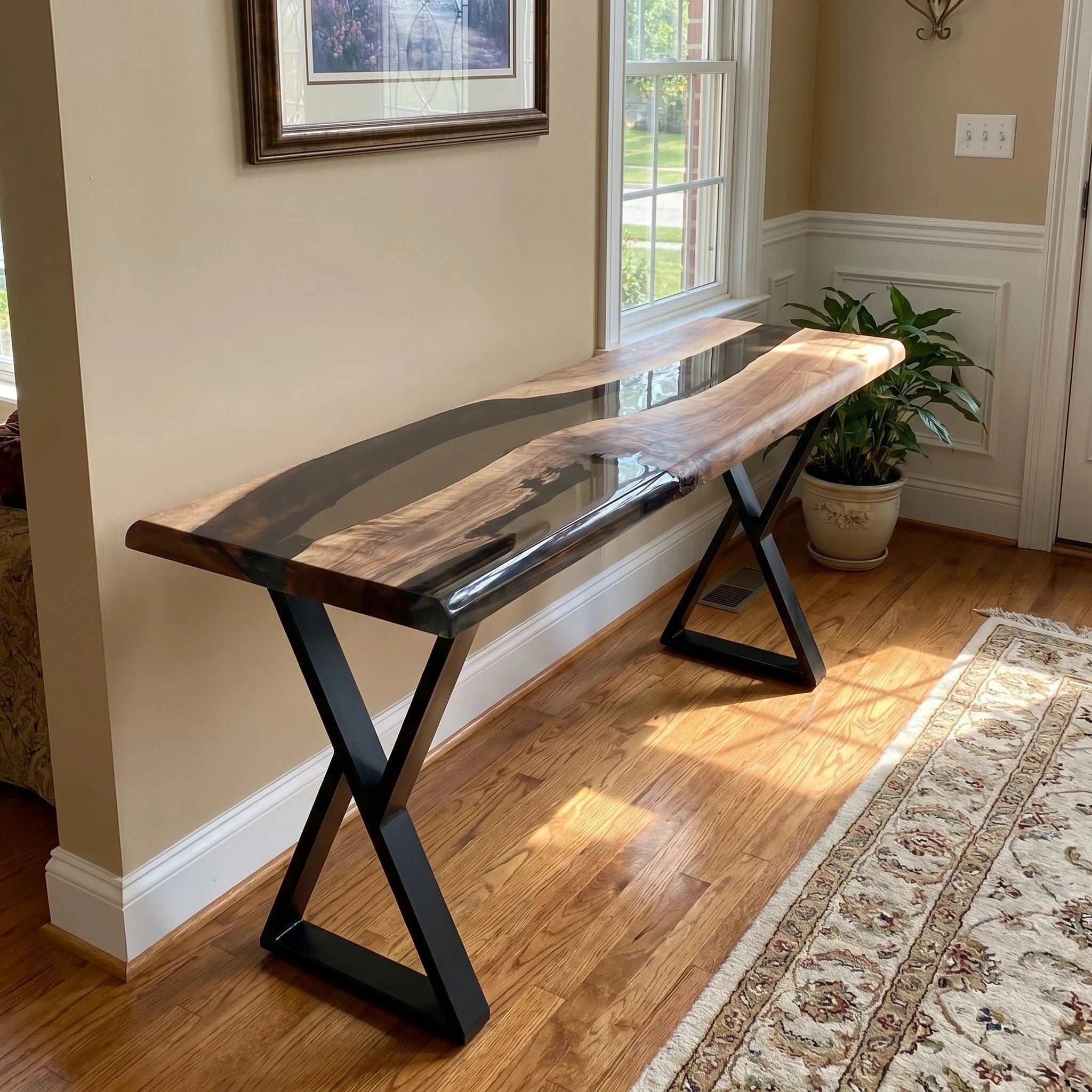 Driftwood walnut console table with live-edge slab and smoky gray resin on black metal X-shaped legs