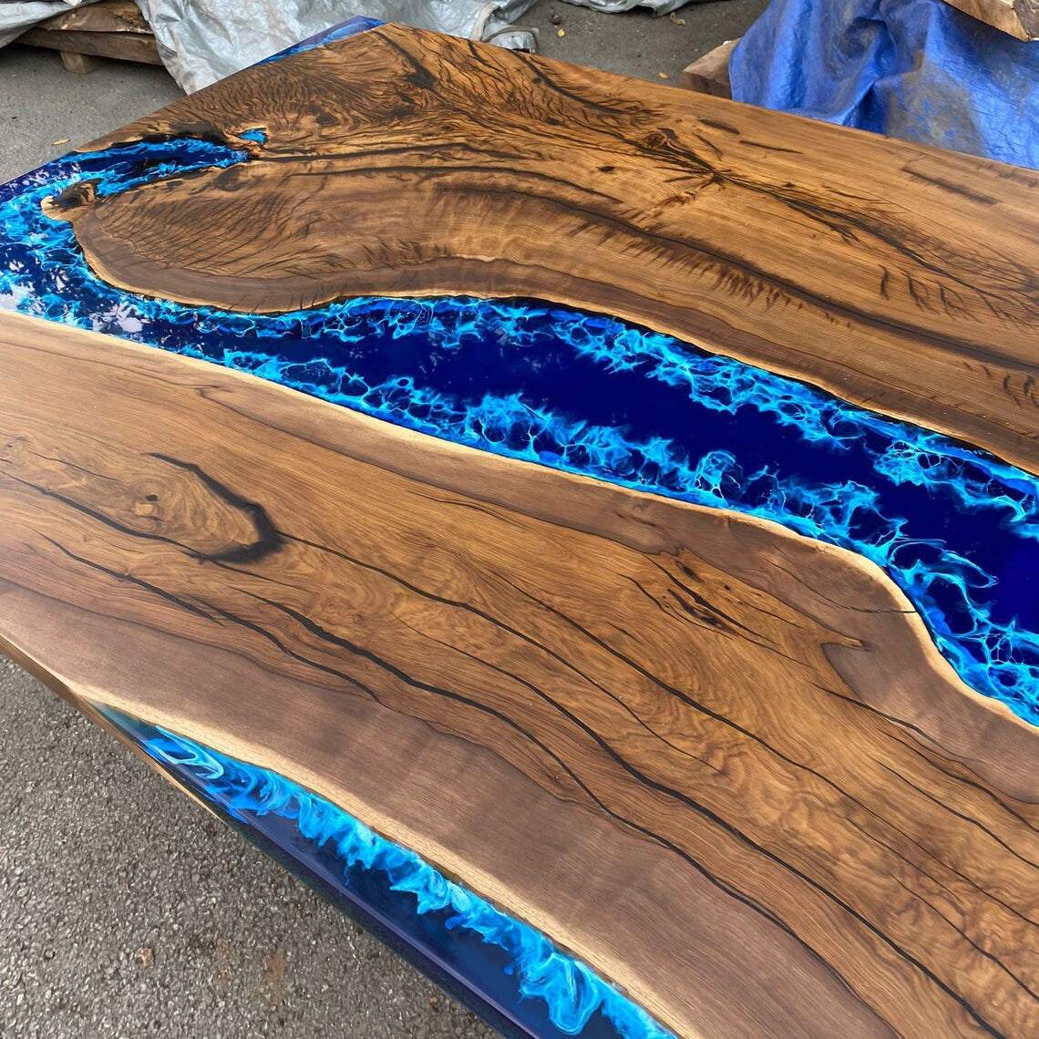 Atlantic Walnut Dining Table with deep blue epoxy river and silver geometric metal base