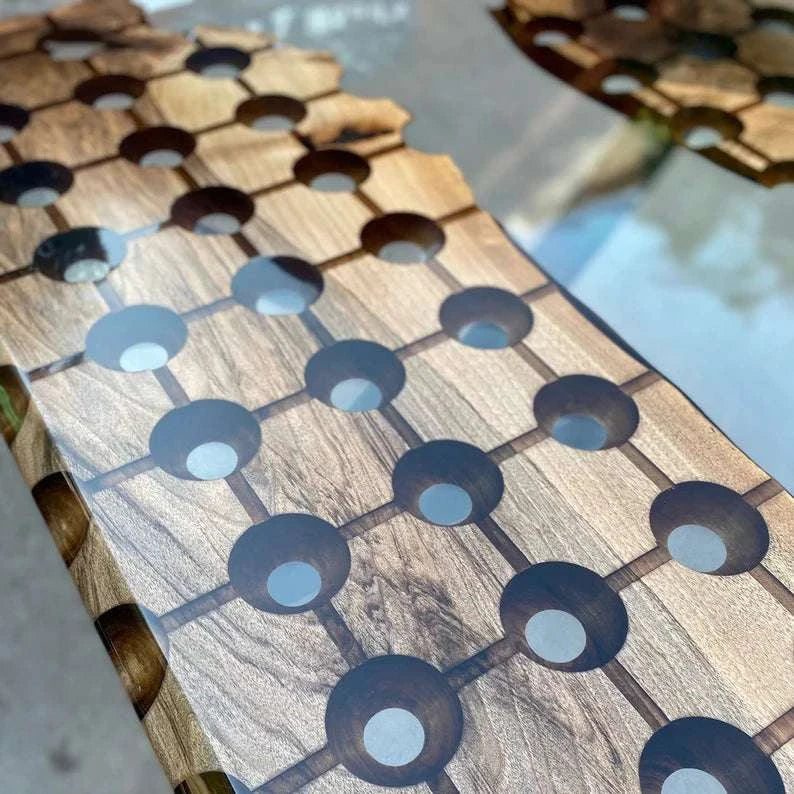 Modern walnut conference table with geometric circular cutouts, clear resin river, floating wood island, and black metal legs