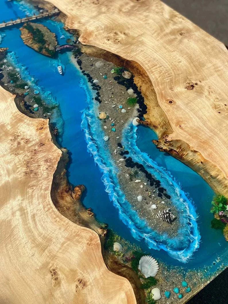 Archipelago Poplar Dining Table with live-edge wood and ocean blue resin river featuring miniature islands and black metal base