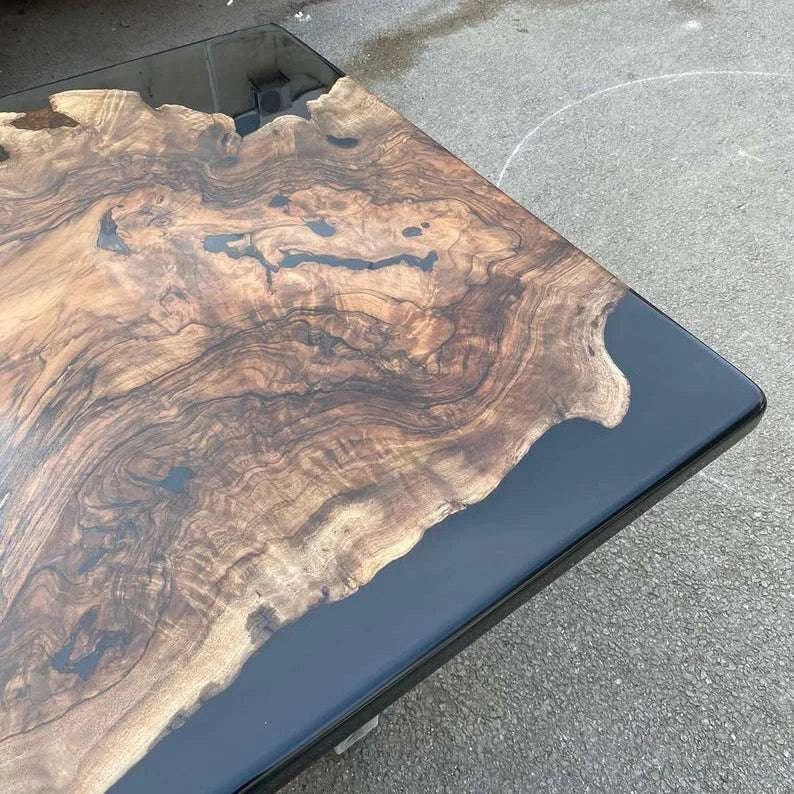 Obsidian Burl Dining Table with walnut burl slab and black epoxy resin on silver metal legs