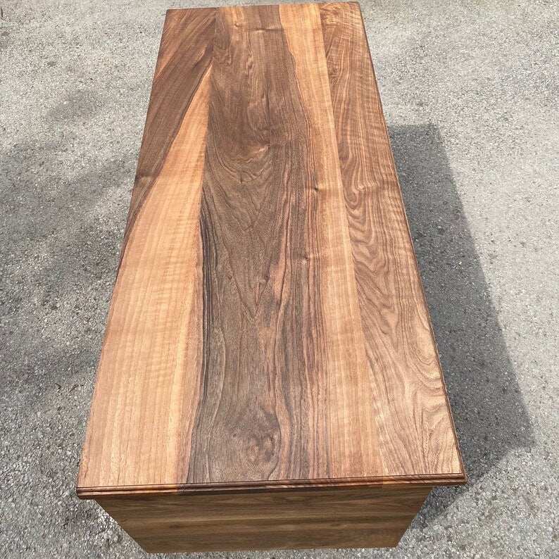 Storm Walnut Storage Bench with swirling gray resin river, solid walnut wood, and black metal legs