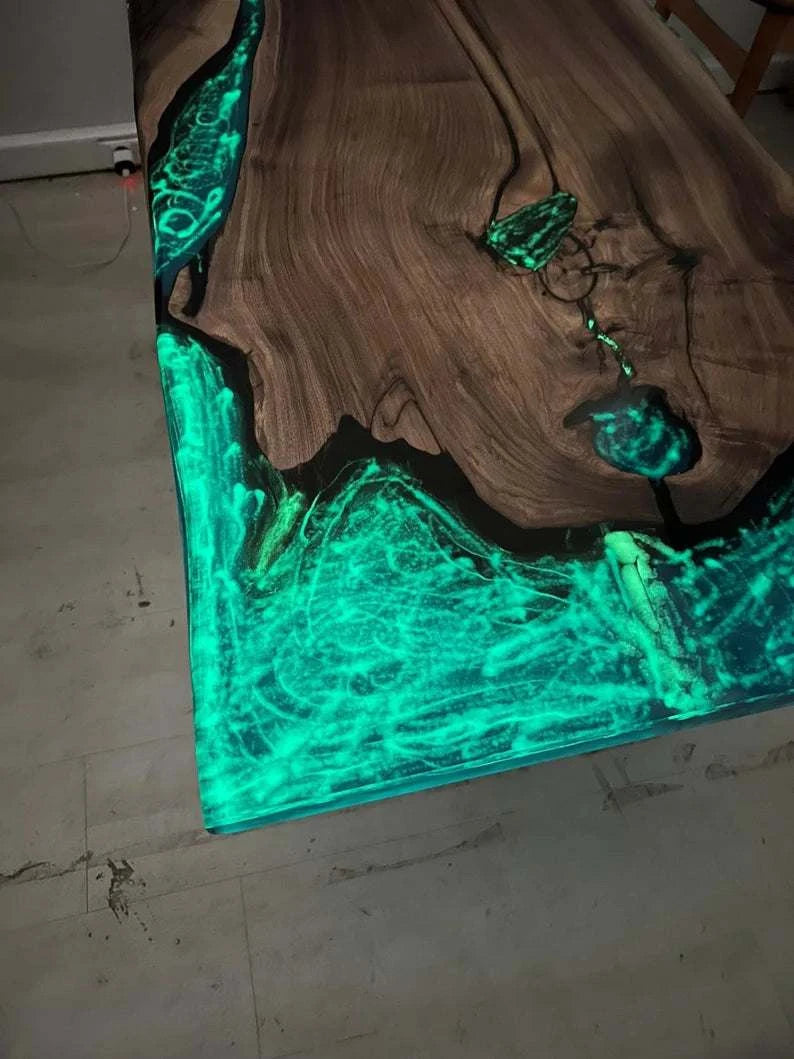Aurora Glow Dining Table showing walnut wood with glowing turquoise phosphorus resin in live edge voids