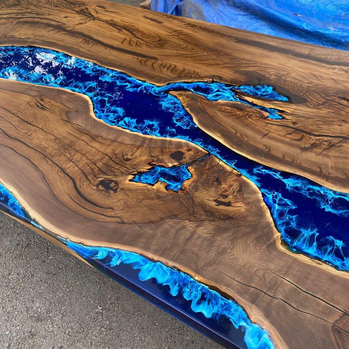 Atlantic Walnut Dining Table with deep blue epoxy river and silver geometric metal base