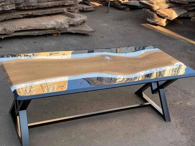 Eclipse Walnut Dining Table with three-tone walnut, matte white, and glossy black resin top and black metal X-base