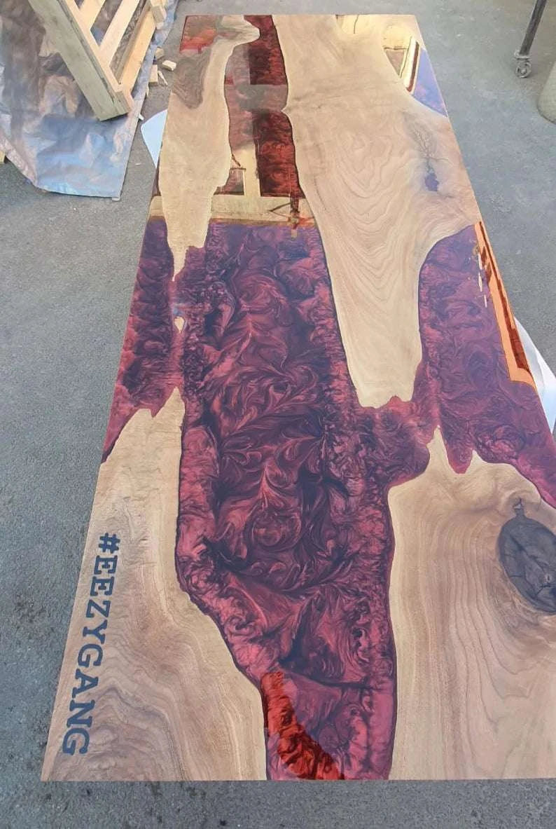 Crimson River Walnut dining table with deep red resin river and solid walnut wood