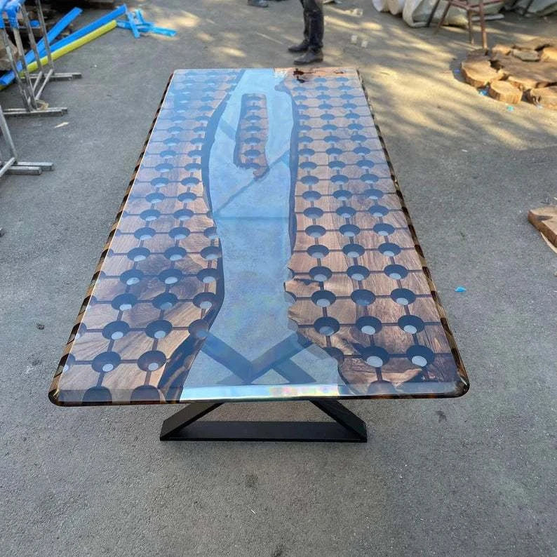 Modern walnut conference table with geometric circular cutouts, clear resin river, floating wood island, and black metal legs
