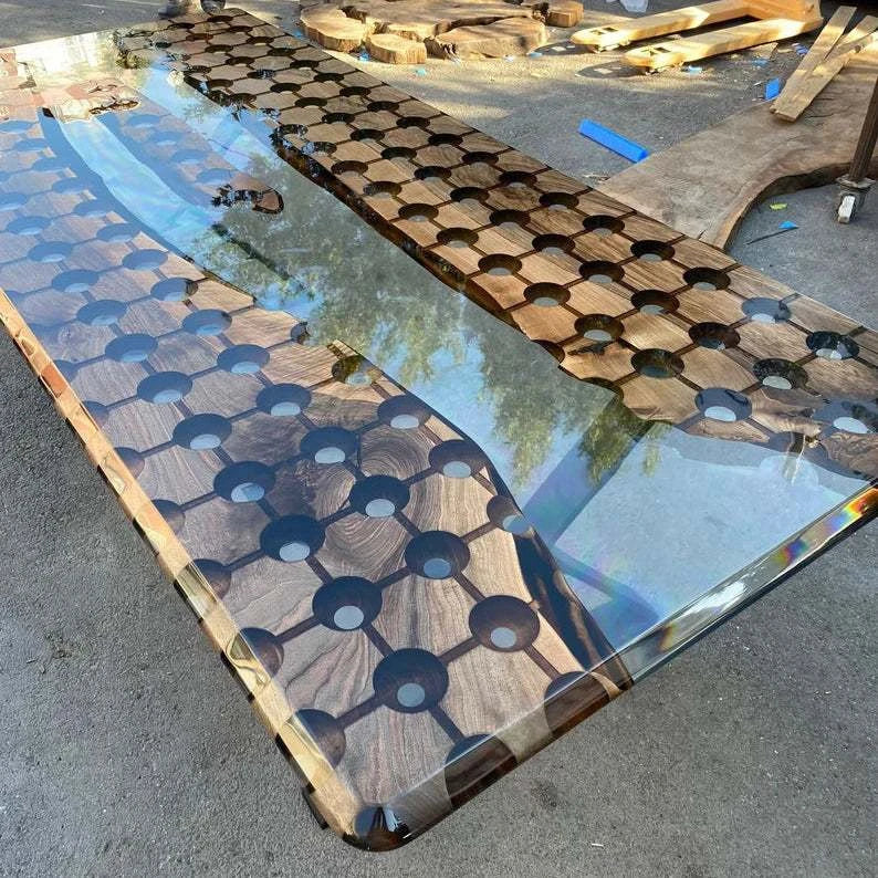 Modern walnut conference table with geometric circular cutouts, clear resin river, floating wood island, and black metal legs