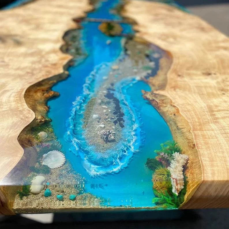 Archipelago Poplar Dining Table with live-edge wood and ocean blue resin river featuring miniature islands and black metal base