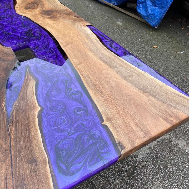 Large live-edge walnut dining table with matte purple amethyst resin river and black metal X-base