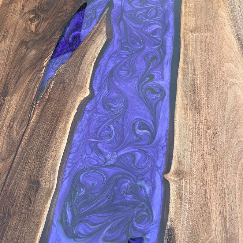 Large live-edge walnut dining table with matte purple resin river and black metal X-base