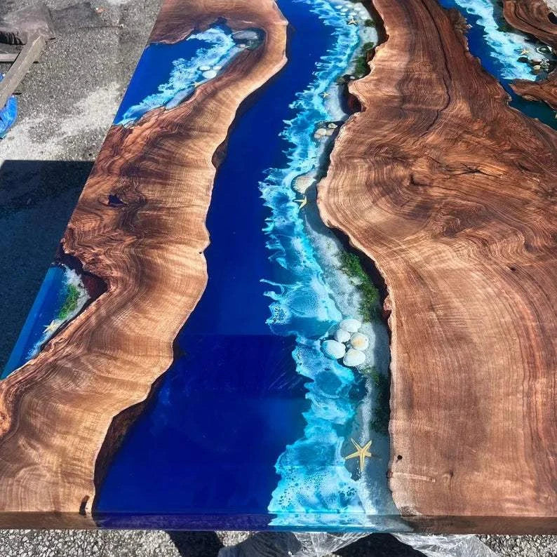 Coral Reef Live Edge Dining Table with walnut wood, blue resin river, real shells, starfish, and black metal base