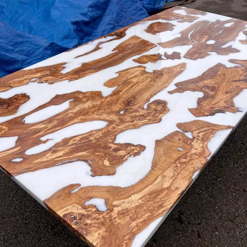 Pearl Lagoon Olive Dining Table with olive burl islands in white matte epoxy and black metal U-shaped legs