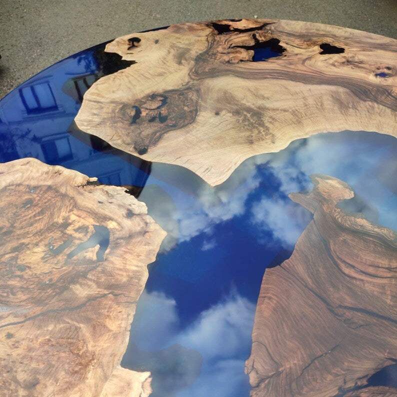 Sapphire Burl Round Dining Table with walnut burl wood and transparent blue resin on black metal base