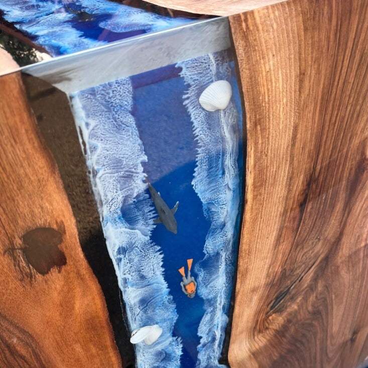 Pacific Crest live edge walnut dining table with ocean-blue resin core and waterfall edge